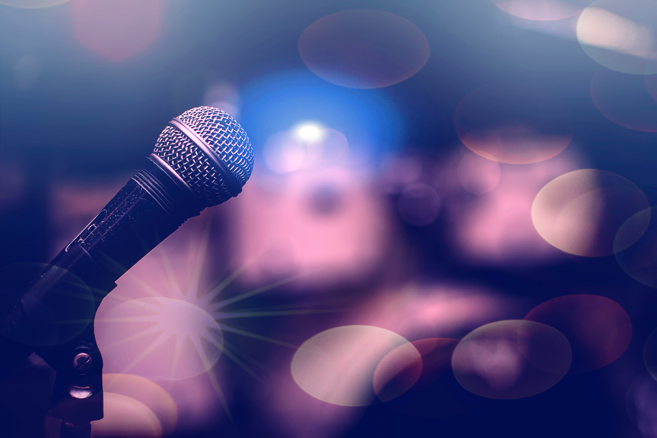 Microphone on a bokeh background. Musical background.